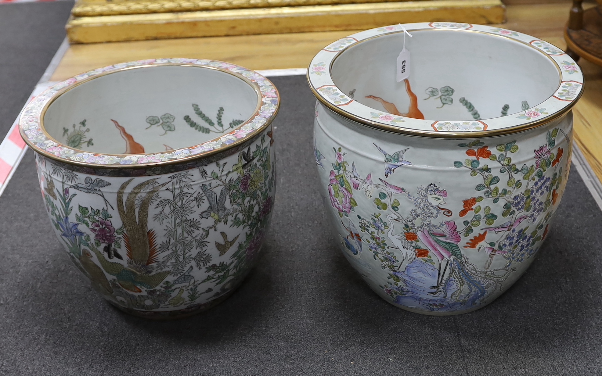 Two Chinese enamelled porcelain fish bowls, decorated with phoenixes and other birds, largest 42cm in diameter